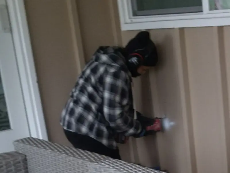 Professional electrician installing an exterior outlet in Bowdoin