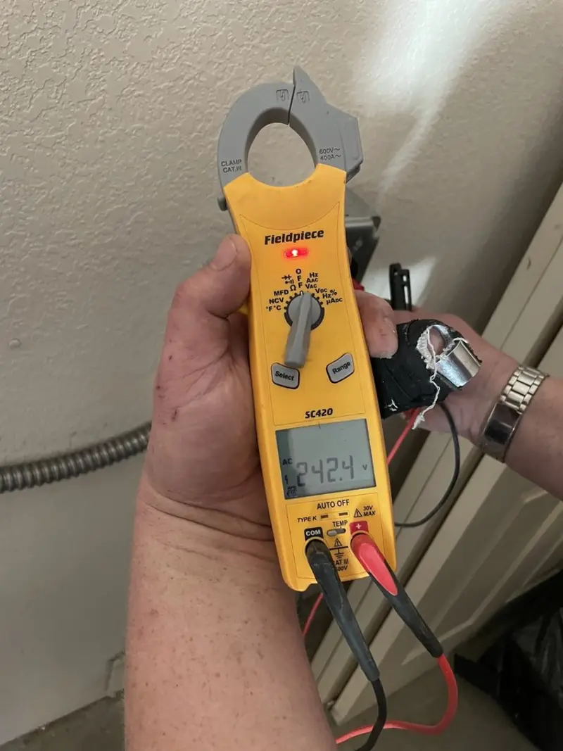 Voltage testing with clamp meter during Electrical Installation Services in Bowdoin